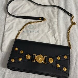 Versace Black and Gold Clutch with cross body bag.